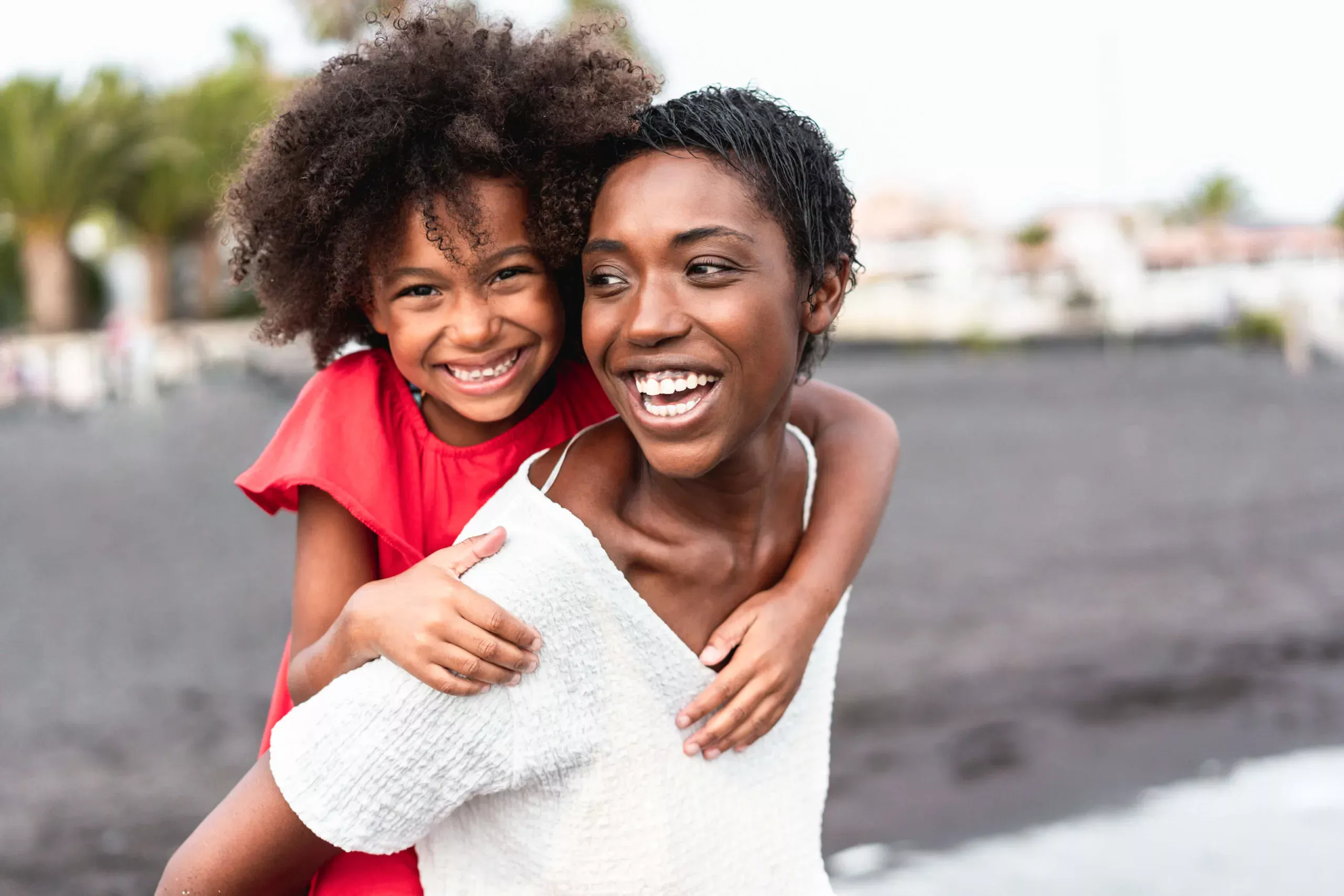 african-mother-daughter-having-fun-beach